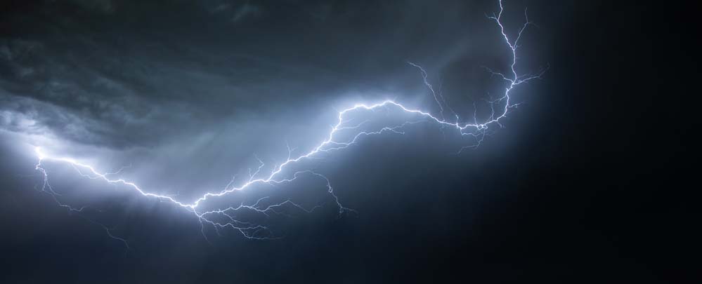 A black sky with a bolt of white and blue lightning