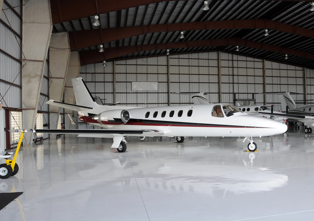 a private jet stored in a hangar